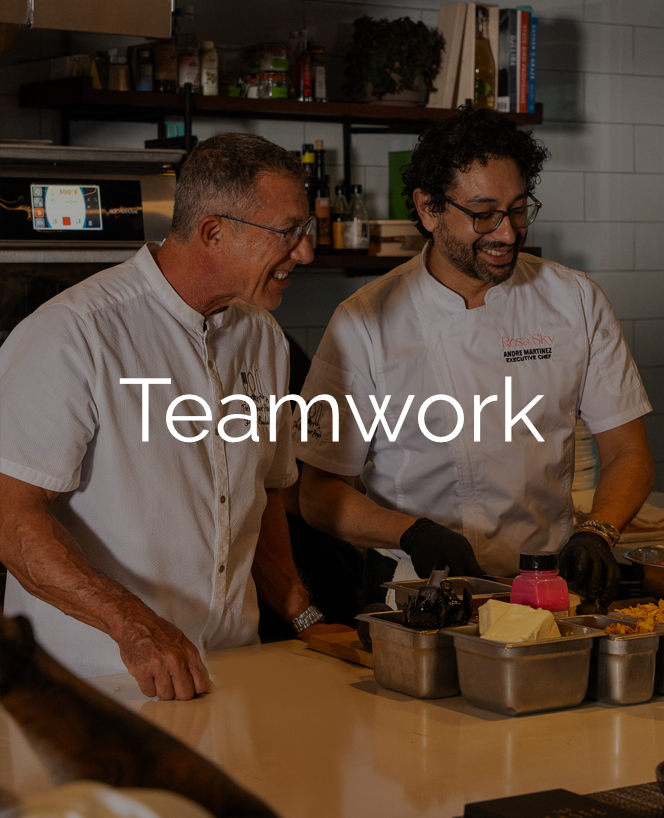 teamwork text over image of two men cooking